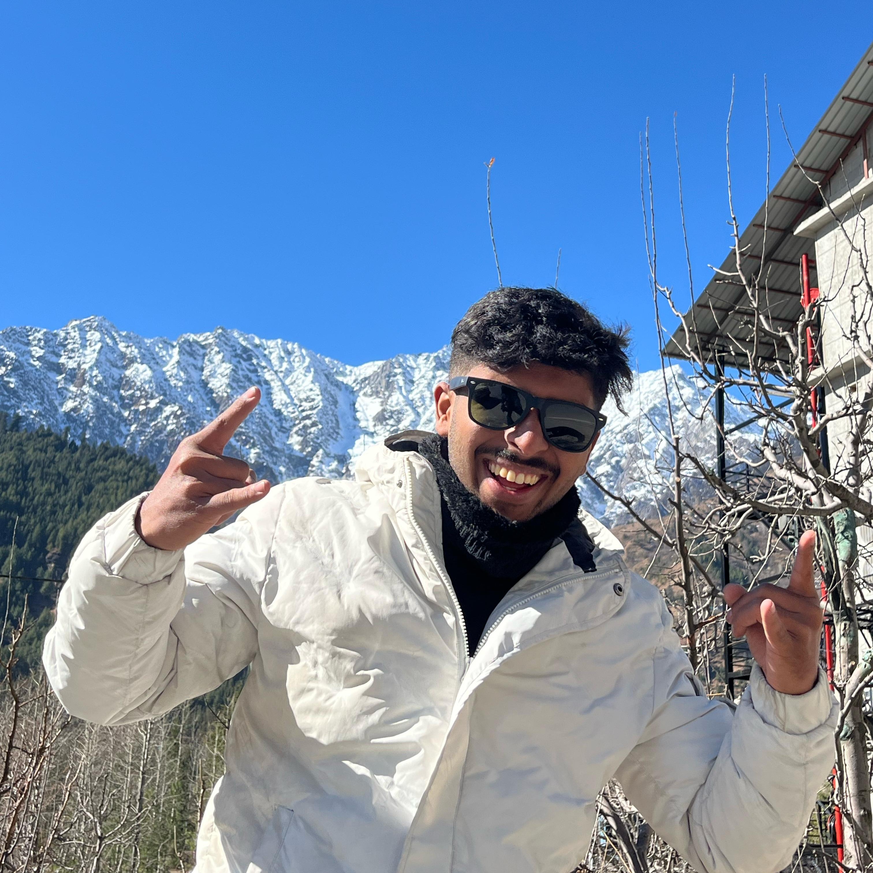 Man in winter gear with snow-capped mountains